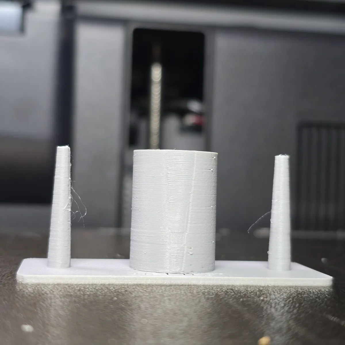Print 2, the same file after drying: posts and ring almost clean, two or three fine hairs and a few tiny specks left.